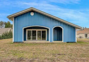 Blue house outside front of barn